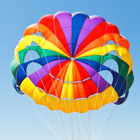 Image of a colorful parachute in the sky